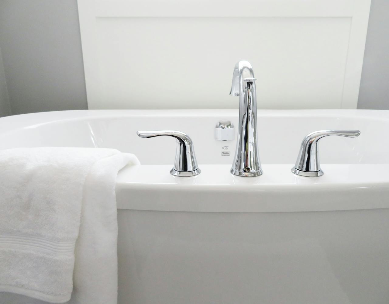 home-img Clean and modern white bathtub with chrome fixtures, perfect for sleek interior design.